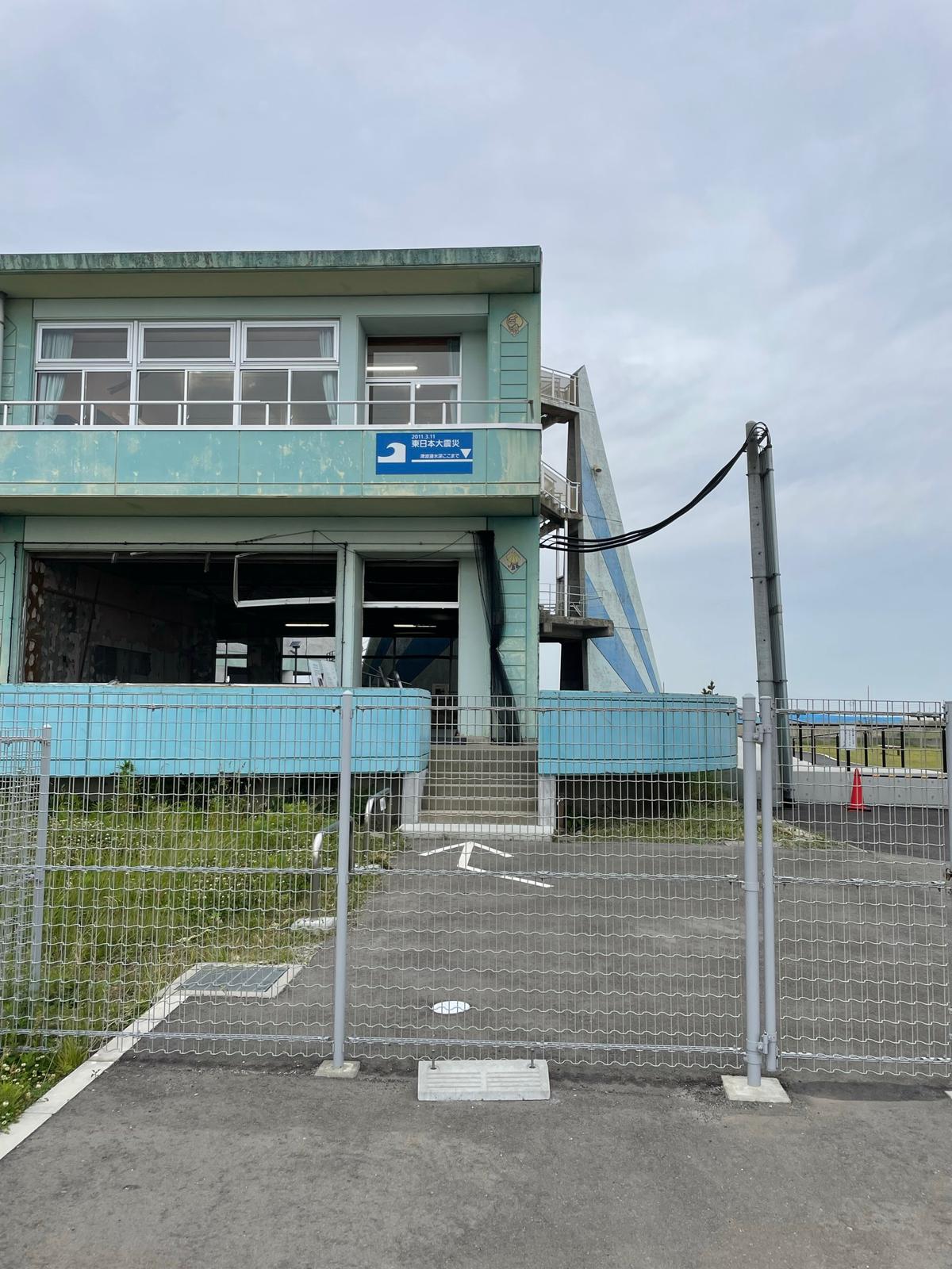 Ukedo Elementary School ruins. A blue sign on the second floor shows how high the water reached during the tsunami.