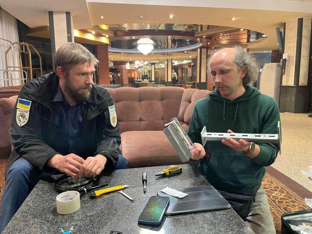 Chornobyl wildlife researcher Andrew Simon (left) and Save Dnipro Technical Director Pavlo Tkachenko (right) discuss the Radnote realtime radiation detector’s unique mounting system, Kyiv, Ukraine, May 6, 2024