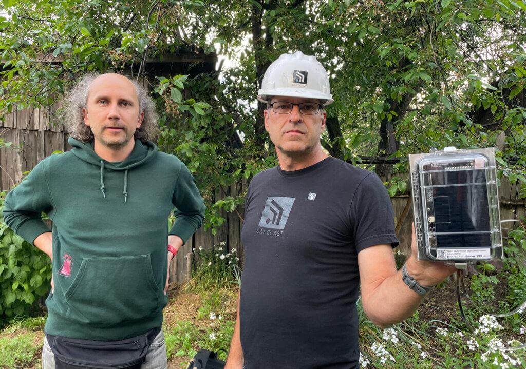 SaveDnipro Technical Director Pavlo Tkachenko (left) and Safecast Lead Engineer Joe Moross (right) prepare to install a Radnote realtime radiation detector in Kyiv, Ukraine, May 6, 2024