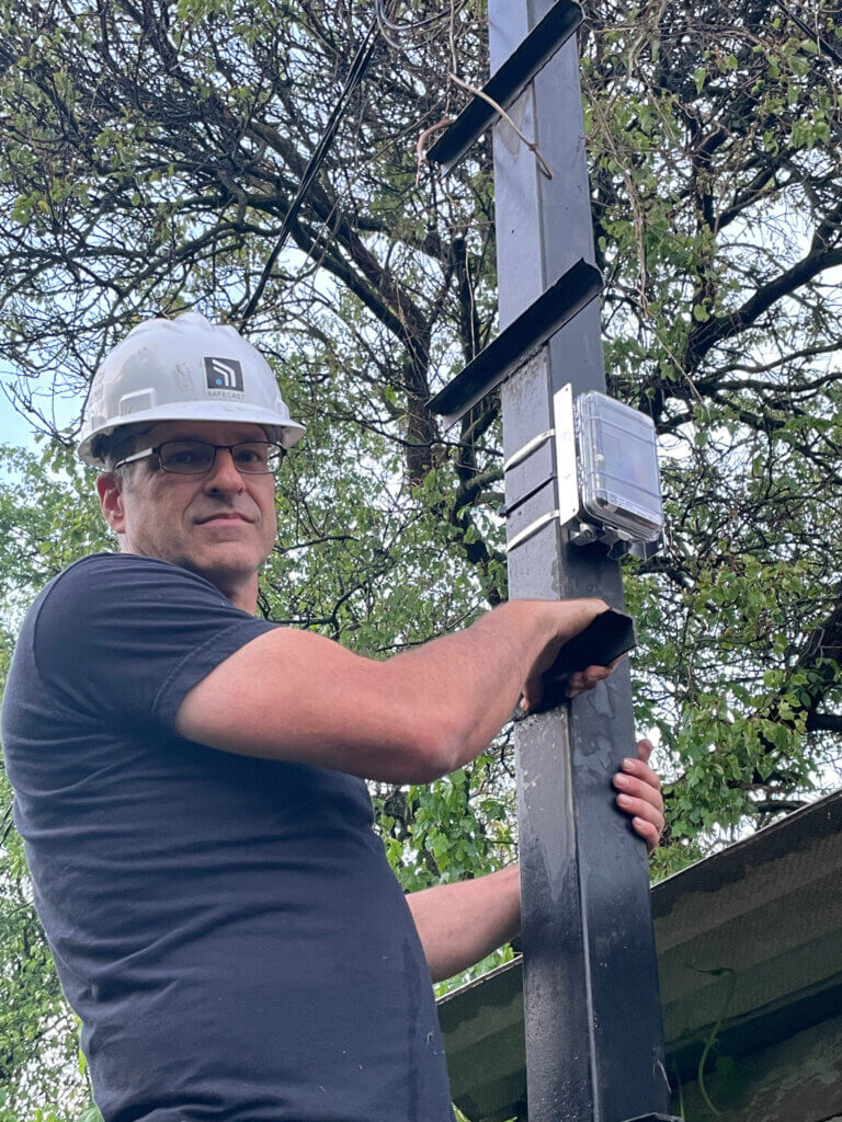 Safecast Lead Engineer Joe Moross completes the installation of a Radnote realtime radiation detector in Kyiv, Ukraine, May 6, 2024