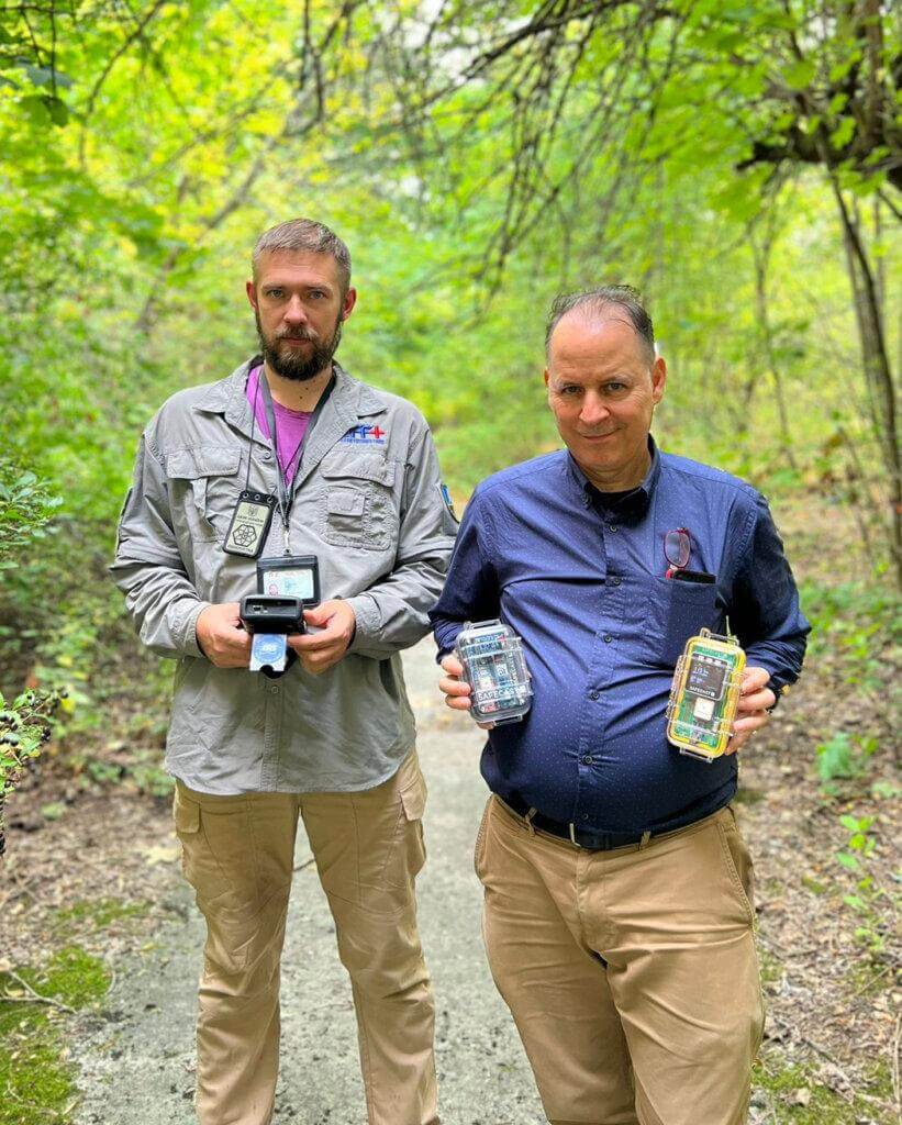 Chornobyl wildlife researcher Andrew Simon (left) and Safecast Lead Researcher Azby Brown (right) test Safecast radiation monitoring devices inside Chornobyl’s Red Forest, September, 2023